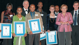 German chancellor, Ms Angela Merkel; training coordinator, Nico Marneweck (right); South African minister of Trade and Industry, Mr Mandisa Mpahlwa (third from right) and Dieter Dilchert, chairman of the Profibus User Group of Southern Africa (third from left) honour the new Certified Profibus Installers